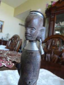 Carved African Warrior Statue. He is 7 1/2 tall and has silver wire 