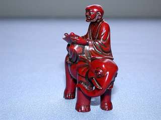 Red Lacquered Chinese Man on Elephant Reading Figurine  