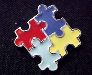 Brand new silver plated and enamel puzzle piece lapel pin tac.